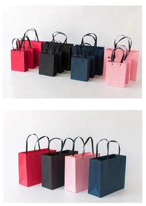 Detail of colorful premium paper gift bags with silk handles in various sizes and colors