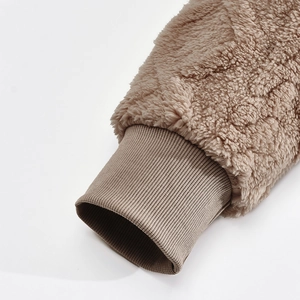 Detailed macro view of khaki faux shearling fabric and ribbed cuffs on men's winter hoodie