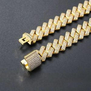 Macro shot of 14mm gold hip hop Cuban chain with pave-set zircons on the box clasp