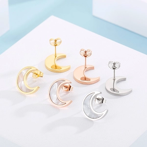 Detailed view of moon-shaped earrings with mother-of-pearl in gold, silver, and rose gold