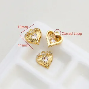 Detailed view of 11mm gold-plated heart pendant with centered cubic zirconia and closed ring