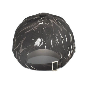 Detail view of the black graffiti baseball cap featuring a metal adjustable buckle strap