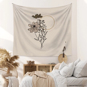 Close-up of bohemian wall tapestry with minimalist botanical line art in a cozy bedroom