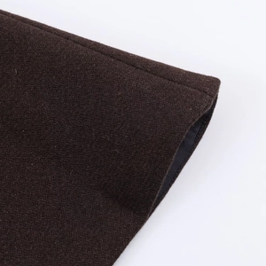 Detailed close-up showing the rich wool texture and stitching on dark brown coat cuffs