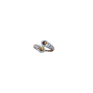 Vintage bypass ring in gold with brown tiger eye stones and zircon accents