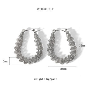 Detail view of silver drop earrings with hollow wire-wrap design and dimensions