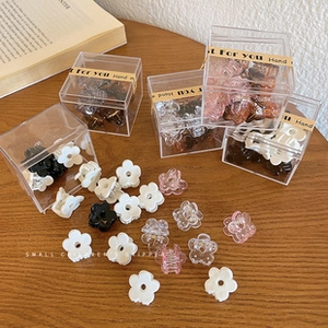 Small flower hair claws in black, white and pink colors with clear acrylic storage box