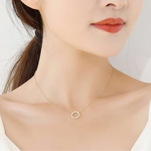 Close-up of S925 silver 14k gold necklace with round zircon pendant on neck