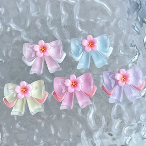 Translucent resin bow accessories with cherry blossoms on textured glass background