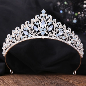 Elegant silver bridal crown with light blue marquise gems and crystals on a wood base