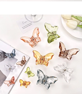 Detailed view of various colorful transparent acrylic butterfly hair claws in two sizes