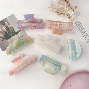 Flat lay of colorful marble textured hair claws in square and half-round styles