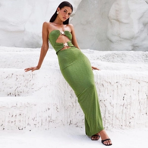 Detail of green backless dress featuring golden starfish metal hardware and knit texture