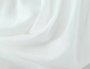 Close-up of white linen fabric texture showing high-quality woven textile details