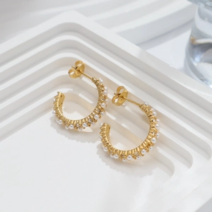 Elegant 18k gold C-shape earrings featuring white pearls and sparkling zircon accents