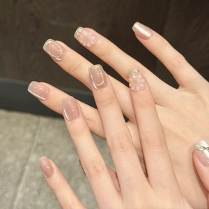 Handmade soft pink press-on nails with 3D white flowers and gold metallic accents