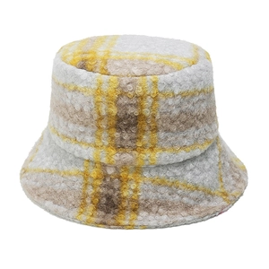 Close-up of yellow and white checkered teddy fleece bucket hat with thick wool texture