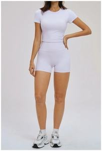Detail of lavender high-stretch yoga set featuring short sleeve top and high waist shorts