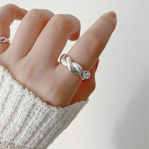 Close-up of minimalist 925 sterling silver twisted rope ring worn on finger