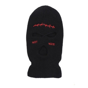 Close-up of black knitted balaclava with red NOT NICE embroidery and wire pattern