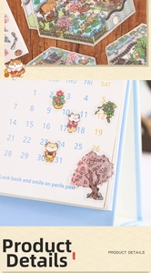 Close-up of semi-transparent cat-themed landscape stickers on a light blue calendar