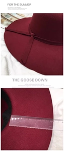 Detail showing a 10cm wide brim of the dark red wool cloche hat with a ruler measurement