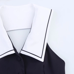Detail of a black and white denim jacket with navy collar and contrast piping