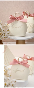 Detail of cream wedding gift box with pink ribbon and round wooden handle