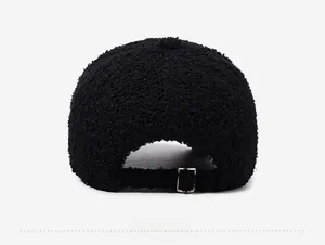 Detail of the back of a black teddy fleece baseball cap with adjustable silver buckle strap