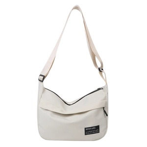Minimalist cream nylon crossbody bag with adjustable strap and brand woven label