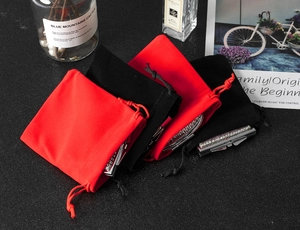 Detail of silver rhinestone jewelry inside red and black velvet drawstring pouches