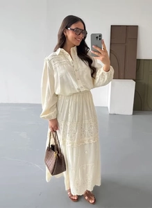 Close-up of bohemian cream lace shirt and tiered skirt set with hollow embroidery details