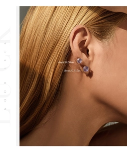 Detailed view of 7mm and 8mm lavender round cut sterling silver stud earrings on model