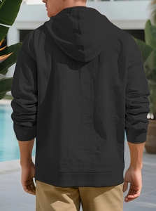 Rear view of black hooded shirt in linen cotton blend worn by the pool outdoor