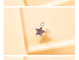 Macro shot of silver star-shaped pendant with purple and pink zircons for DIY jewelry