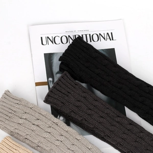 Detailed cable knit texture of fingerless long gloves in four neutral classic colors