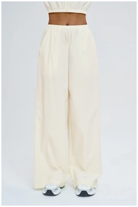 Detail view of high-waisted elastic waistband on beige loose-fit hiking pants for women