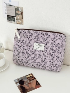 Dettaglio della borsa per cosmetici in velluto a coste floreale viola con trapuntatura