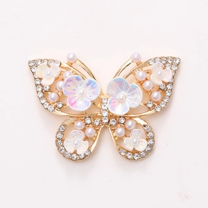 Golden butterfly alloy accessory with sparkling rhinestones, pearls and iridescent flowers