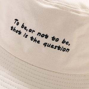 Minimalist cream-white bucket hat with black Shakespeare embroidery on twill cotton fabric