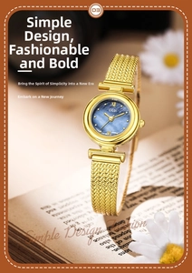 Close-up of gold quartz watch with blue pearl dial on a vintage book background