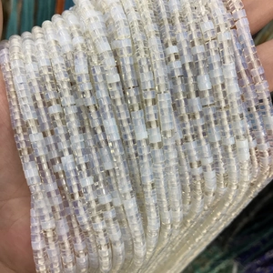 Close-up of cream semi-transparent 2x4mm tube stone beads for DIY jewelry making