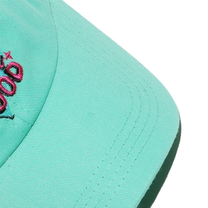 Detailed close-up of mint green canvas baseball cap with high-quality embroidery