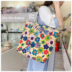 Detail of floral canvas tote bag with thick cotton rope handles and colorful patterns