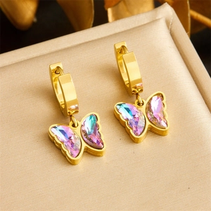 Golden butterfly earrings with gradient crystals on a beige jewelry display box