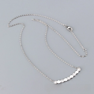 Macro detail of silver geometric hexagonal pendant necklace with pavé cubic zirconia