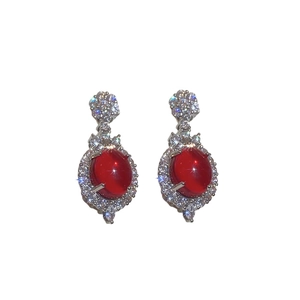 Exquisite silver floral earrings featuring oval red crystals and pavé diamond halo