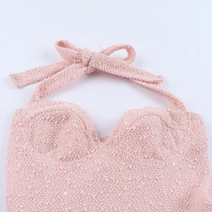 Detail of pink halter dress with shimmering sequins and soft wavy knitted texture