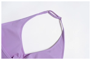 Detail of adjustable straps and stitching on a purple brushed yoga tank top