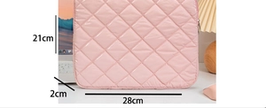 Pink quilted laptop sleeve measuring 28x21x2cm with a stylish diamond stitch pattern